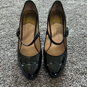Black patent leather Mary Jane heels.